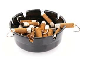 Cigarette butt flies in an ashtray