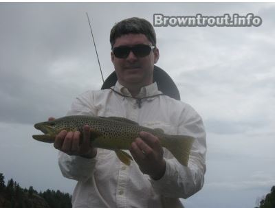 A Georgia resident Kyle Rush holding a brown trout caught fly fishing. georgia trout fishing maps, trout stream maps georgia, ga trout fishing maps