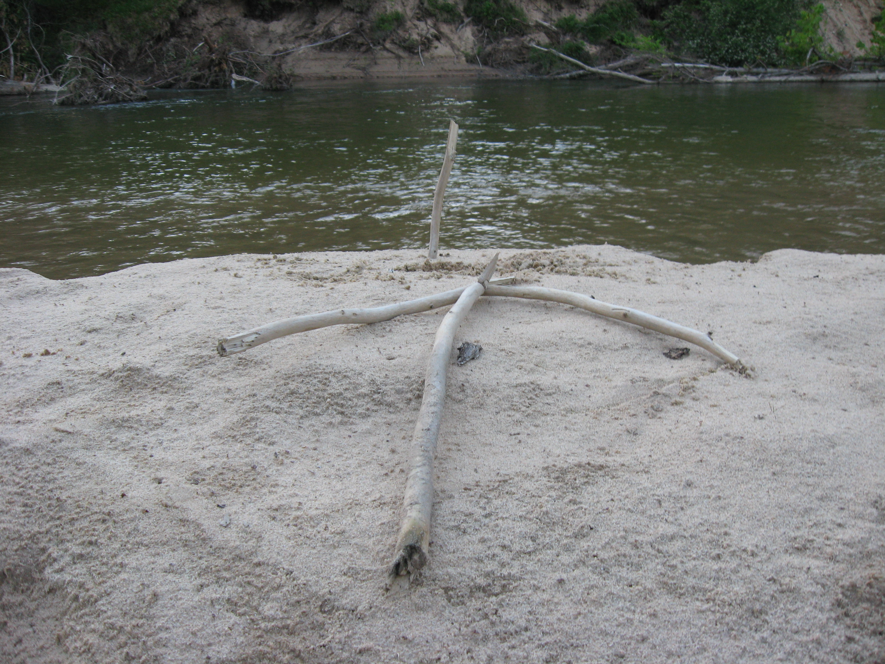 Wooden arrow marking a good fishing spot