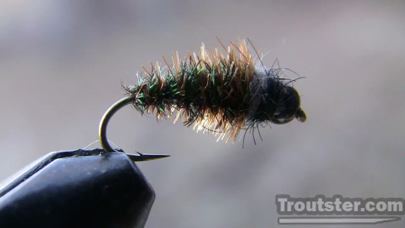 Black bead head caddis pupa made from peacock herl and brown hackle, Caddis Pupa Fly Patterns, sedge pupa fly pattern, caddis pupa emerger, caddis pupa fly tying patterns, sparkle caddis emerger, black caddis pupa patterns