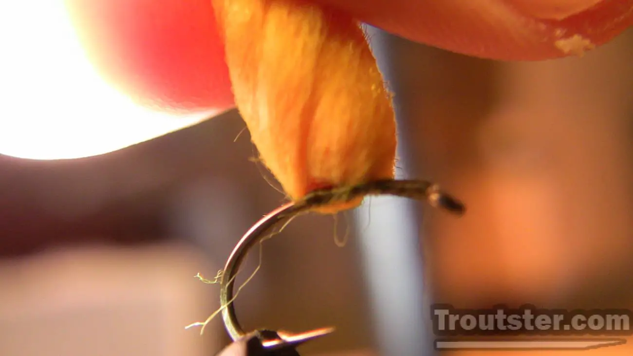 Cutting egg yarn and shaping it into a circular pattern.,  egg fly patterns