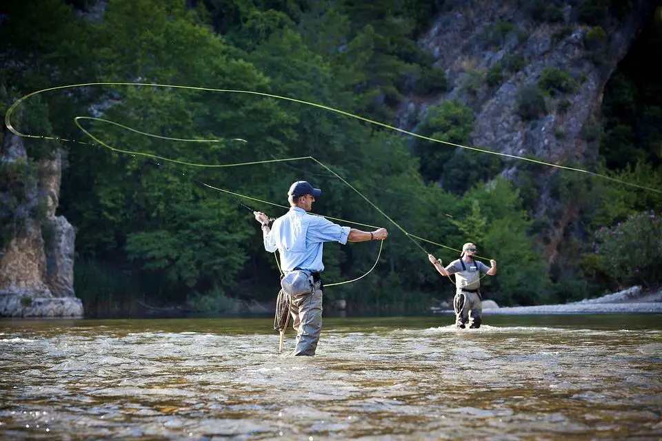 Anglers mending fly line on a river